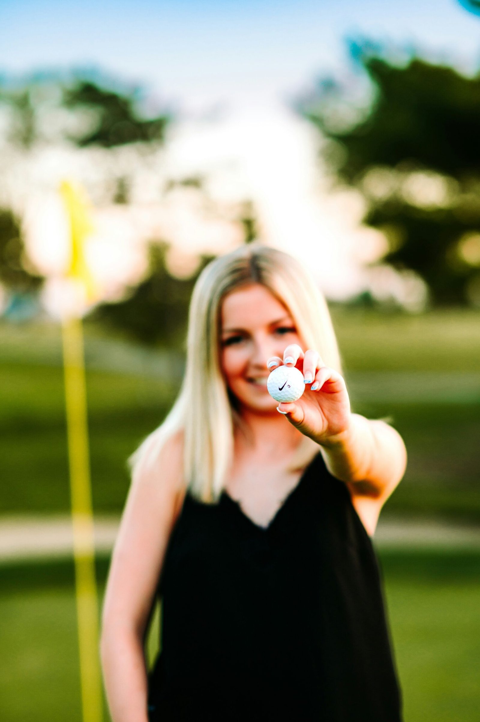 a woman in a black dress holding a white object